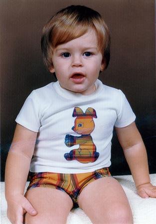 Me as a young boy wearing tartan shorts and a white T-shirt with a tartan bunny on the front