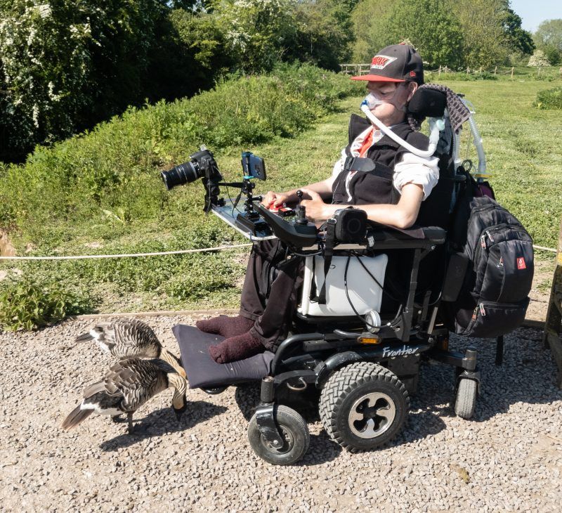 Daniel Baker after his wheelchair issues had been fixed at Slimbridge with Geese feeding from his footplate 