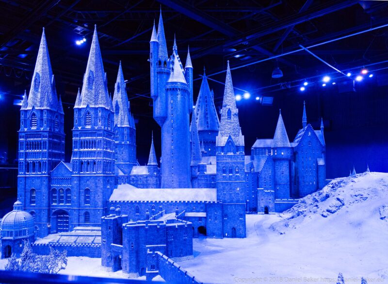 A model of Hogwarts in the snow lit by a blue light