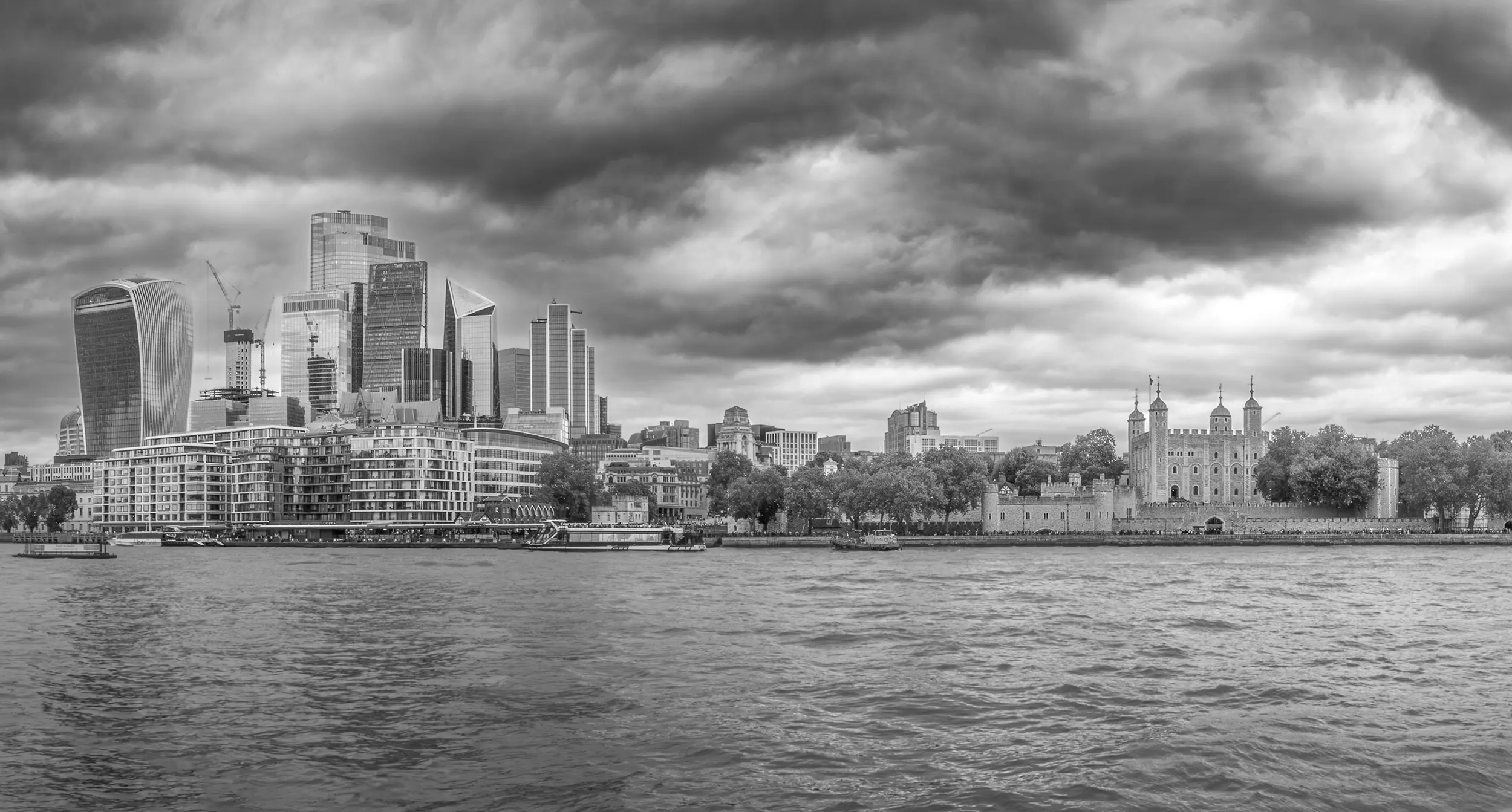 Black and white image of London square mile and the Tower of London across the Thames taken by Daniel Baker