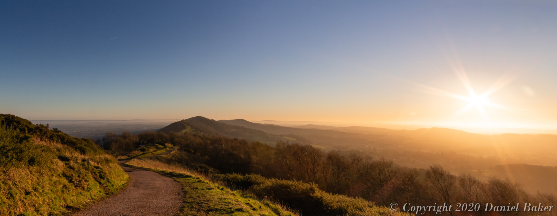 An orange sunset bathing the Malvern hills glowing light