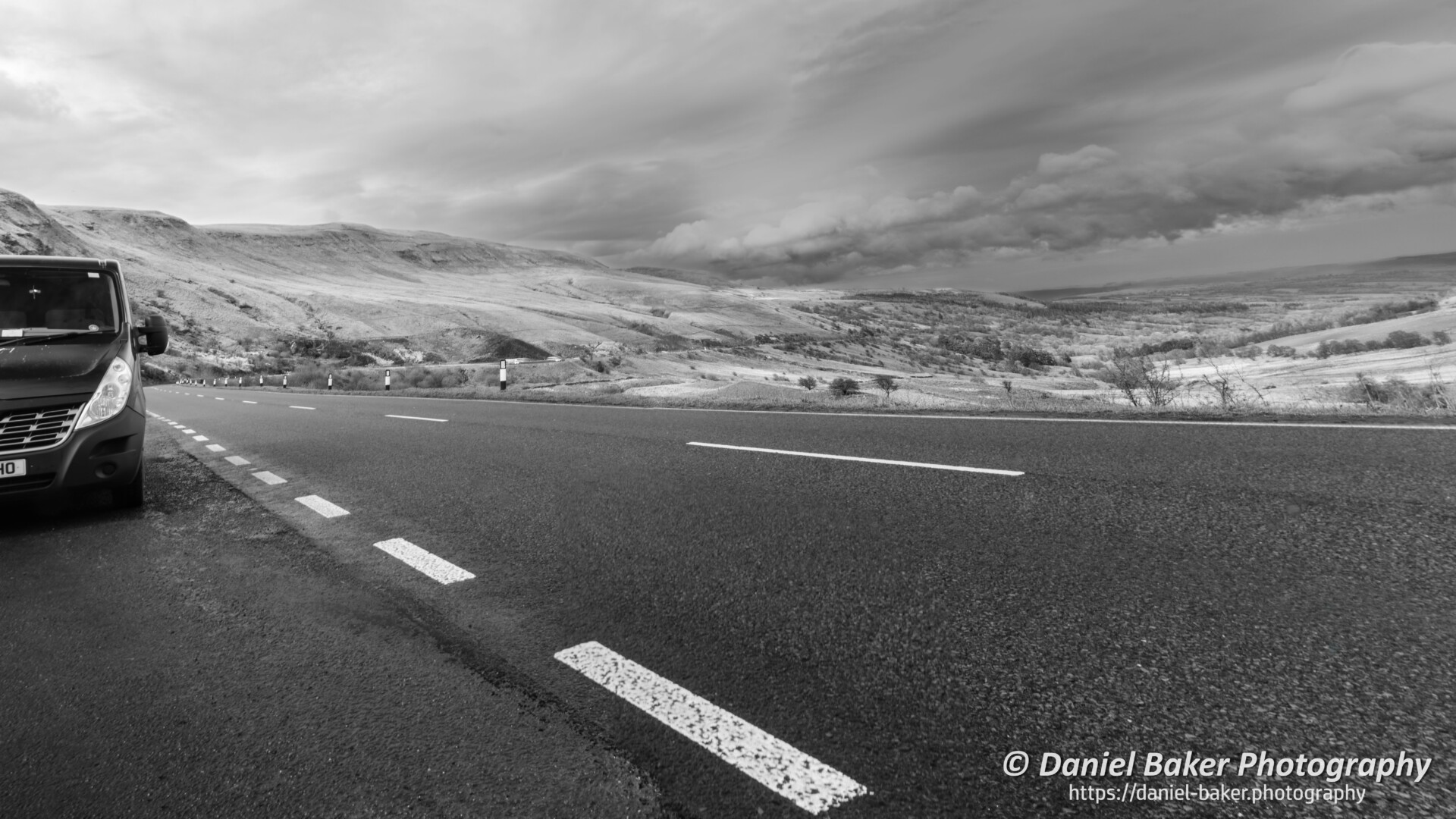 Panoramic view of a road running through the beautiful natural landscape of Wales.